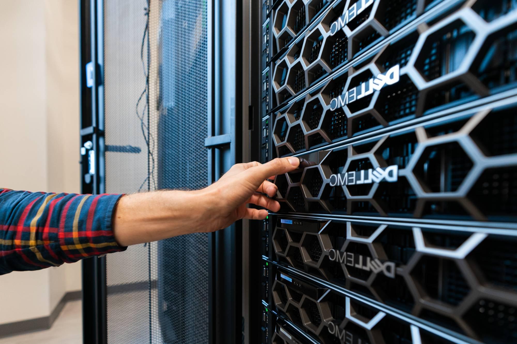 Person working on server rack.